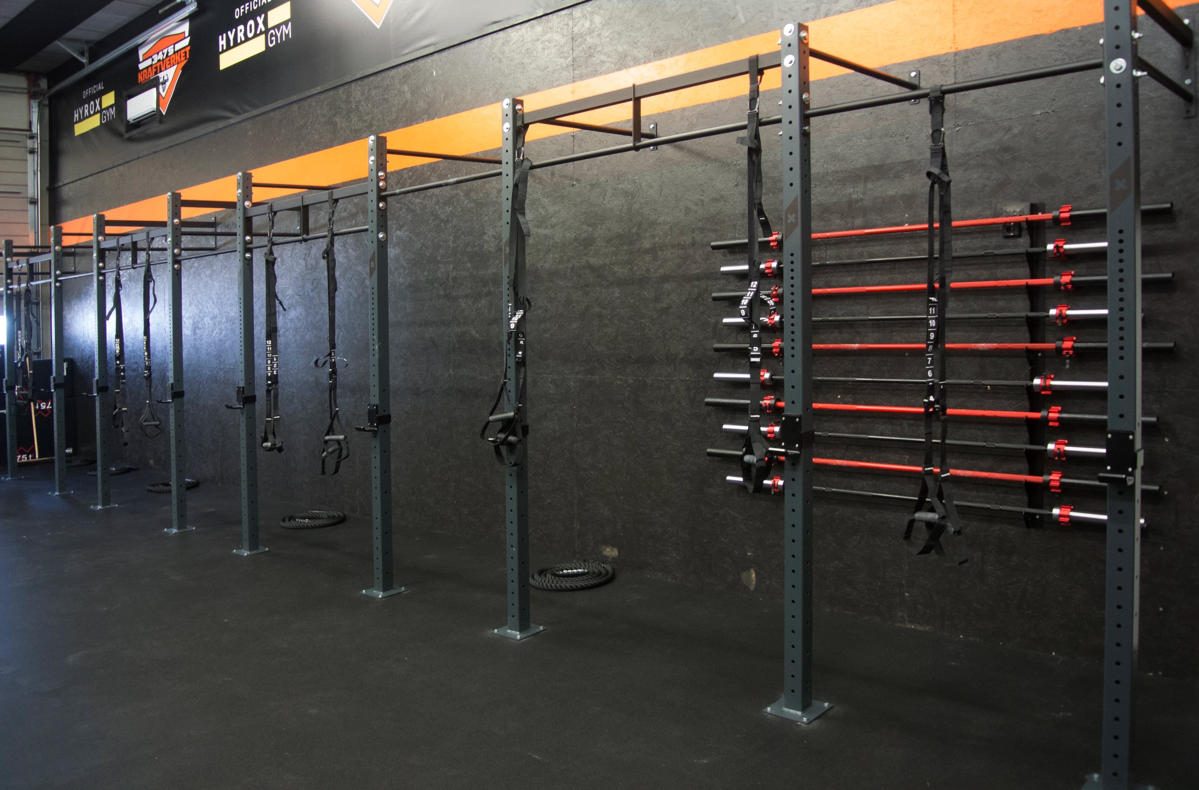 Rigg med vektstenger og HYROX GYM-skilt i The Box