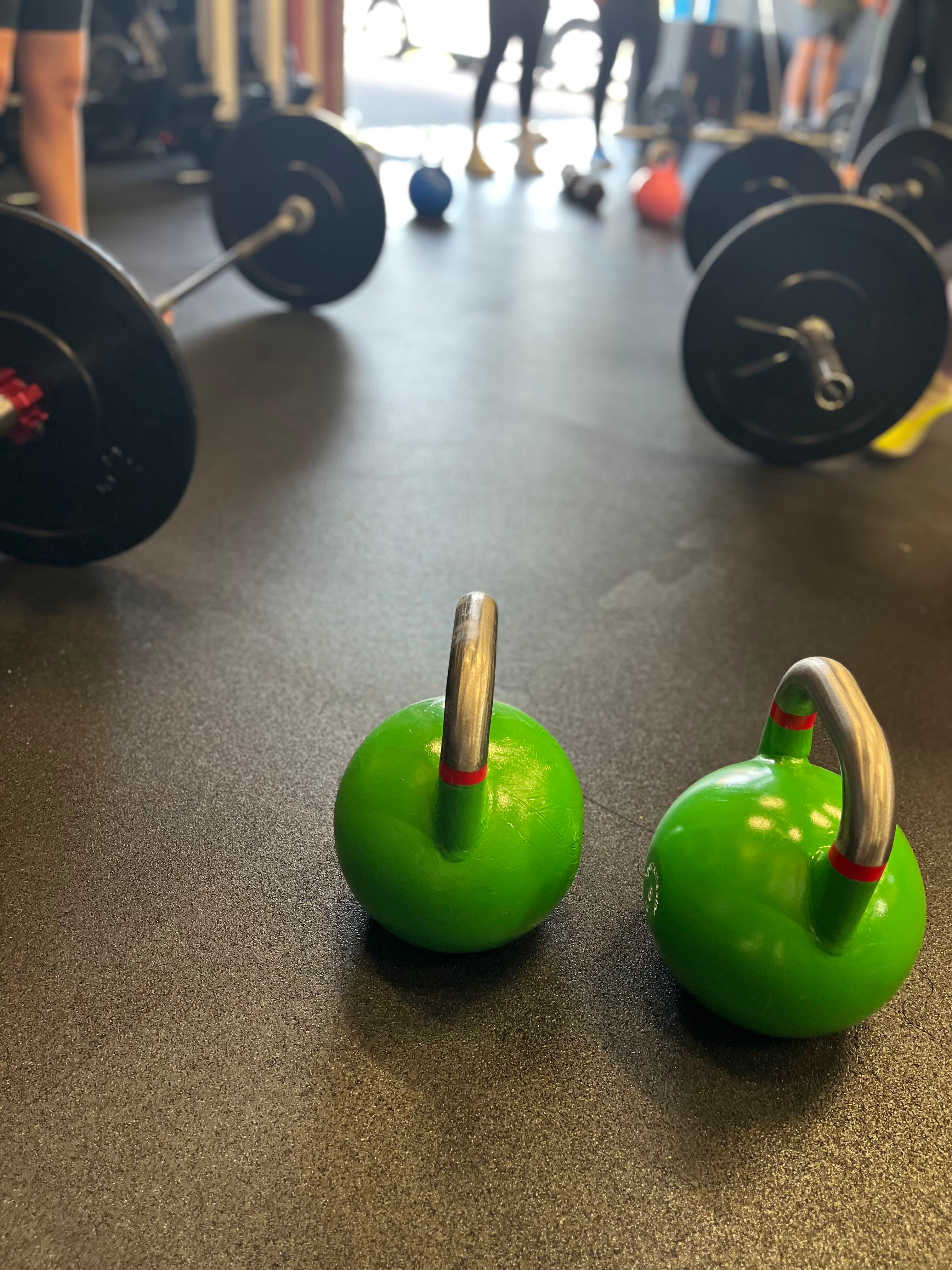 Kettlebells foran en gruppe som trener